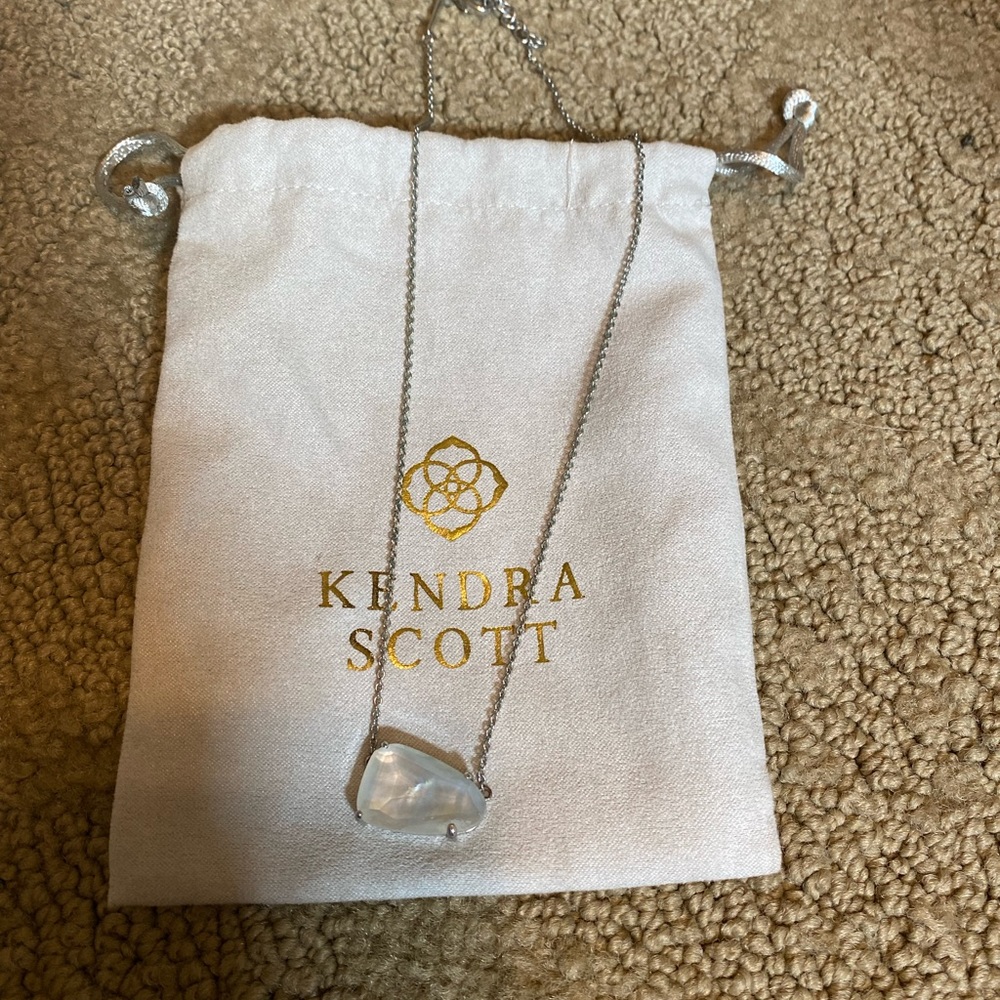 Beautiful white stone set in silver metal.  Only worn once!